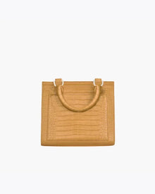 Back view of the Marigold Croc Kids Mini by Modern Picnic, featuring the marigold yellow croc-embossed vegan leather exterior, structured rectangular shape, stitched panel detailing, and dual top handles on a white background.