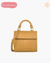 Front view of the Marigold Croc Kids Mini by Modern Picnic, featuring a marigold yellow croc-embossed vegan leather exterior, structured top handle, and adjustable crossbody strap. Displayed on a clean white background with “Kid Collection” text and a star graphic in the corner.