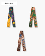 Set of three Modern Picnic printed bag scarves displayed upright on a white background, showcasing three unique designs — a fruit print, a tropical print, and a brown colored themed print — with a “Save $20” label in the top left corner.