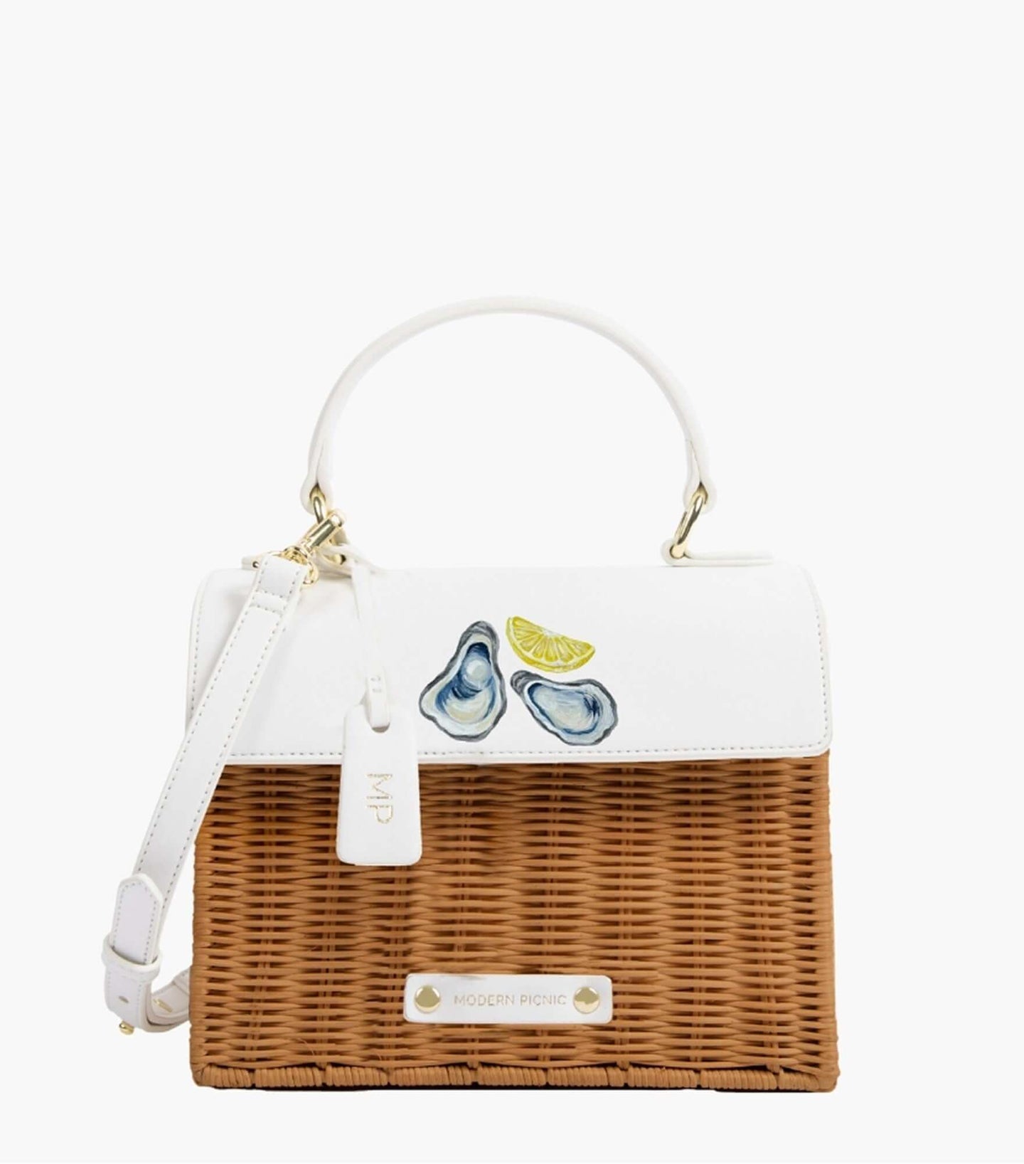 Front view of the Natural Wicker Oyster Mini by Modern Picnic, featuring a hand-woven natural wicker body, white vegan leather flap with printed oysters and a lemon slice, top handle, and gold hardware.