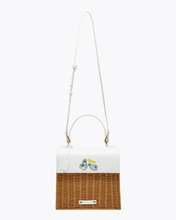 The Natural Wicker Oyster Mini by Modern Picnic shown with a full-length adjustable white crossbody strap, featuring a hand-woven natural wicker body and white vegan leather flap with printed oysters and a lemon slice on a white background.