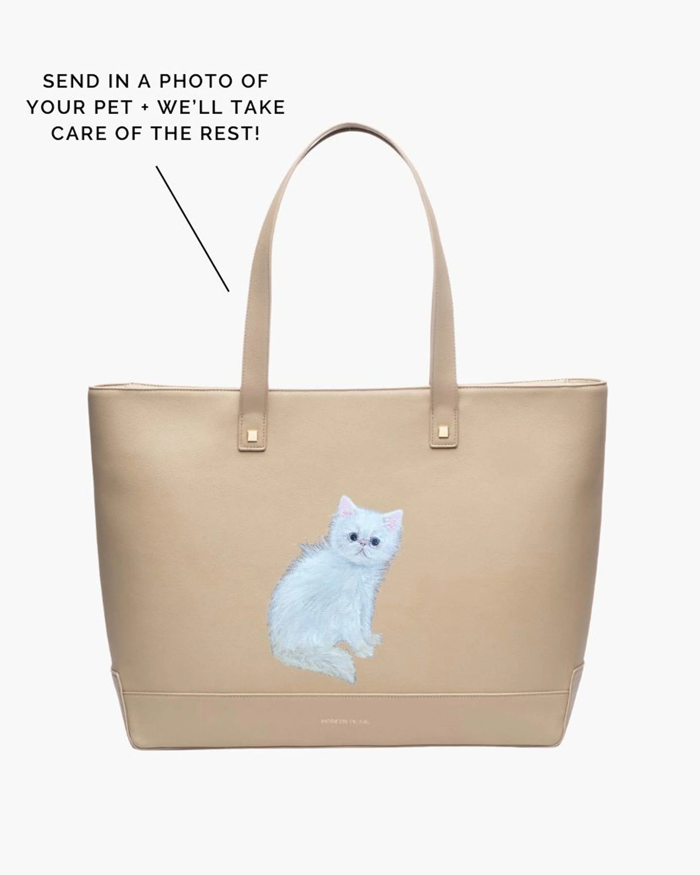A studio shot of a large cream tote bag featuring a custom hand-painted portrait of a fluffy white cat. Text overlays explain the custom process: 