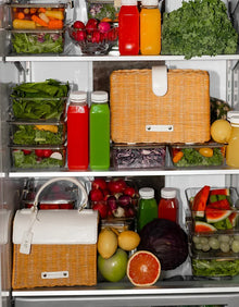 Insulated woven lunch bags in a refrigerator with fresh fruits, vegetables, and juice bottles