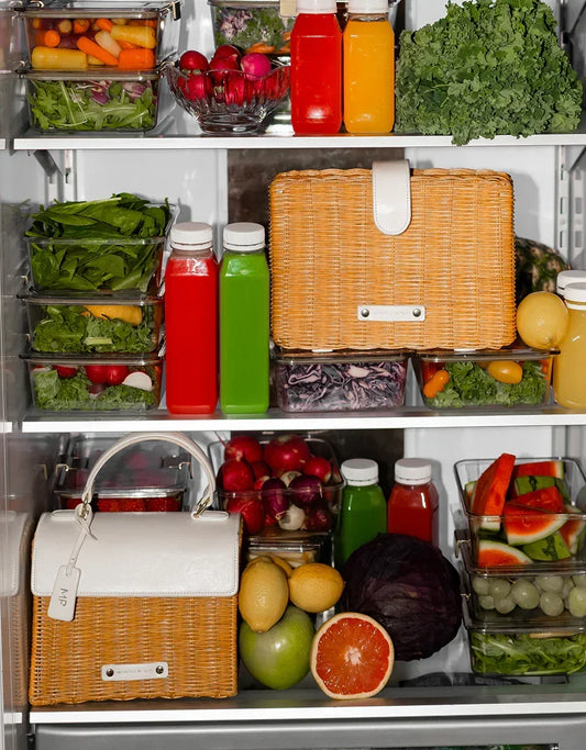 Insulated woven lunch bags in a refrigerator with fresh fruits, vegetables, and juice bottles
