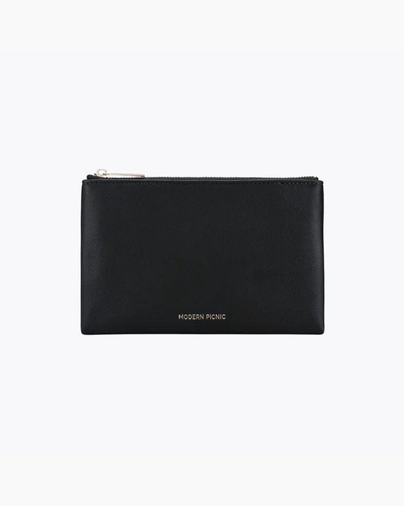 A front-facing studio shot of a small, rectangular black pouch. The bag is made of pebbled vegan leather and features a gold zipper along the top. The gold 
