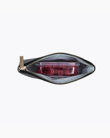 An overhead view of a small black zippered pouch with the zipper open, revealing the white insulated interior holding a clear, rectangular container full of fresh red raspberries.