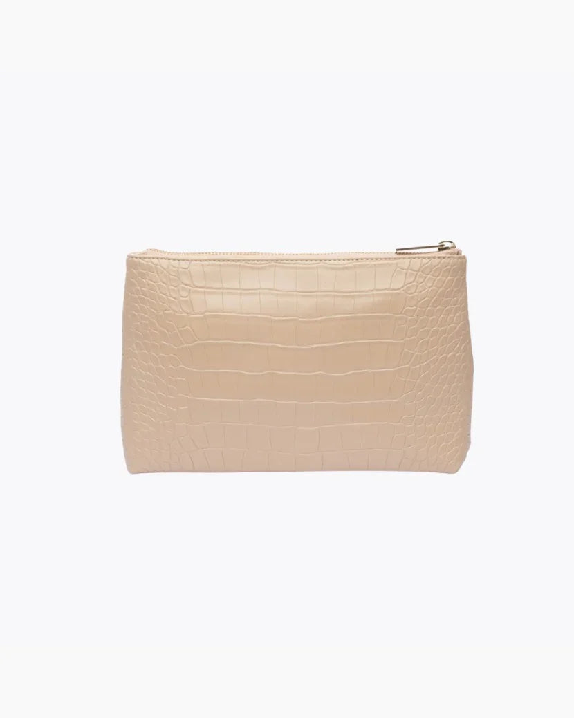 A back-facing studio shot of a rectangular cream pouch made of crocodile-embossed vegan leather, featuring a gold zipper closure at the top.