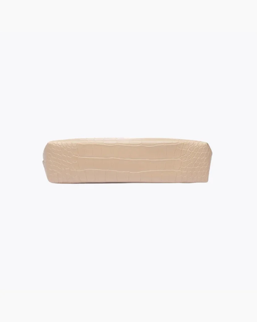 A view of the flat, rectangular base of the small cream pouch, showing the crocodile-embossed texture.