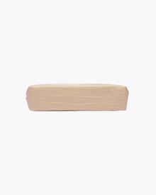 A view of the flat, rectangular base of the small cream pouch, showing the crocodile-embossed texture.