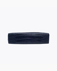 A view of the flat, rectangular base of the small navy blue pouch, showing the crocodile-embossed texture.