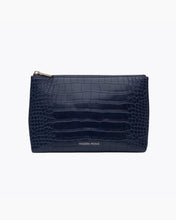 A front-facing studio shot of a small, rectangular navy blue pouch. The bag is made of crocodile-embossed vegan leather and features a gold zipper along the top. The gold "MODERN PICNIC" logo is stamped near the bottom center.