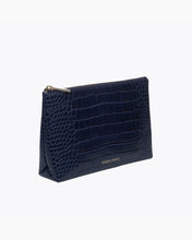 A three-quarter studio shot of a small navy blue zippered pouch with an all-over crocodile-embossed texture. The bag has a gold zipper and a visible gold "MODERN PICNIC" logo along the side base.