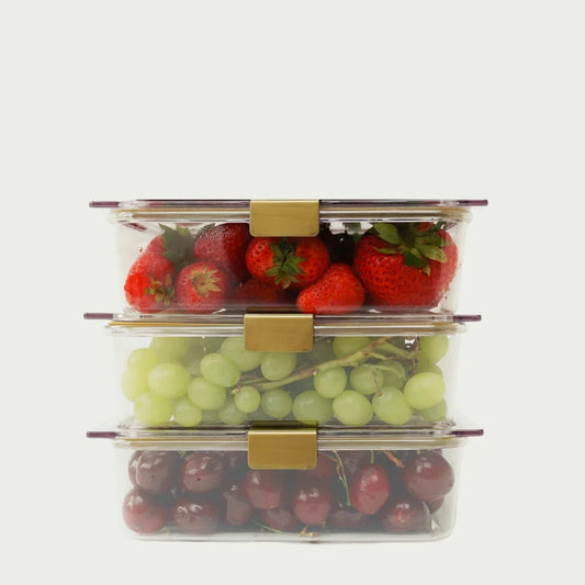 Stacked glass food containers with strawberries, green grapes, and cherries inside