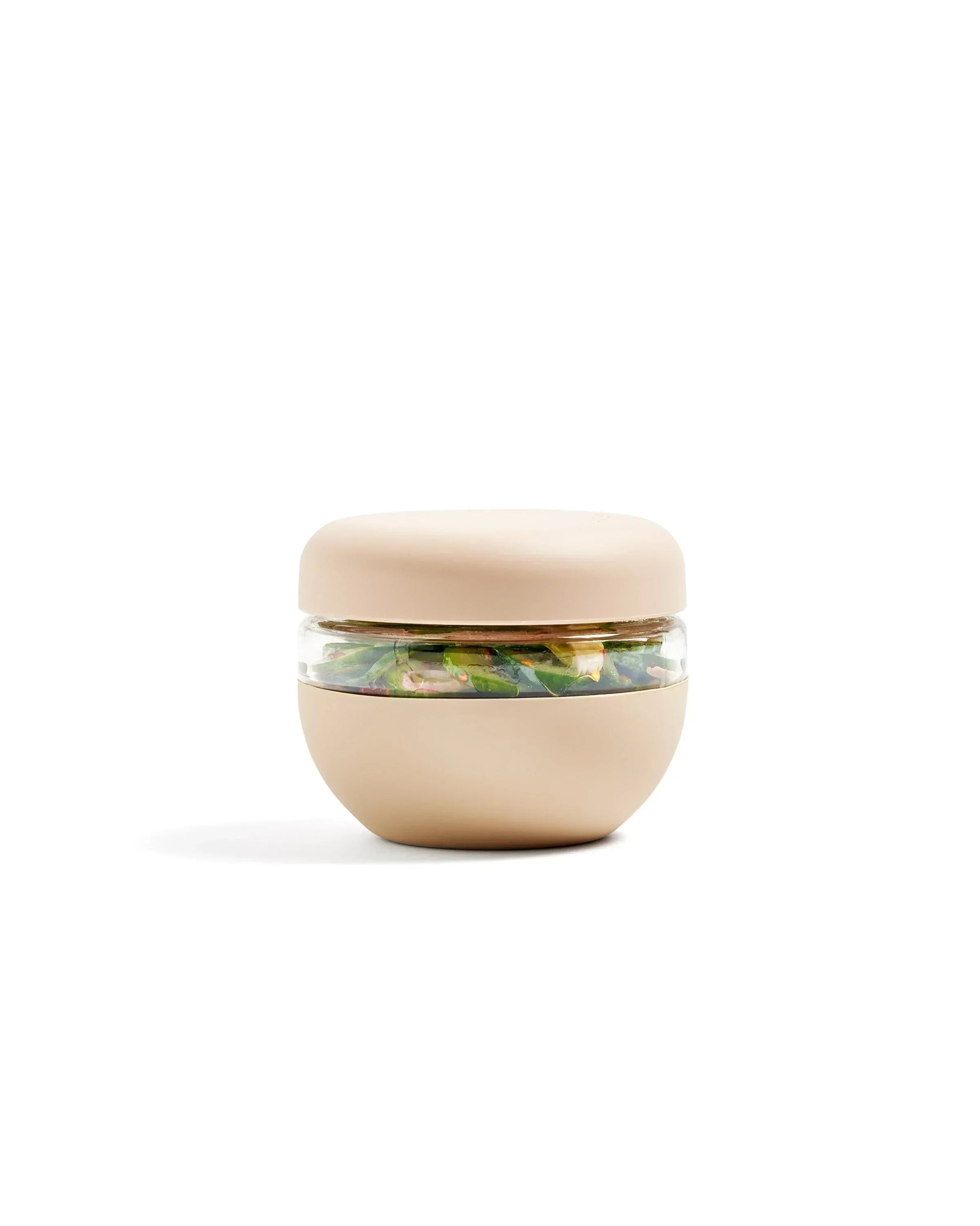 Oat-colored insulated food storage bowl with clear middle, filled with salad, on white background