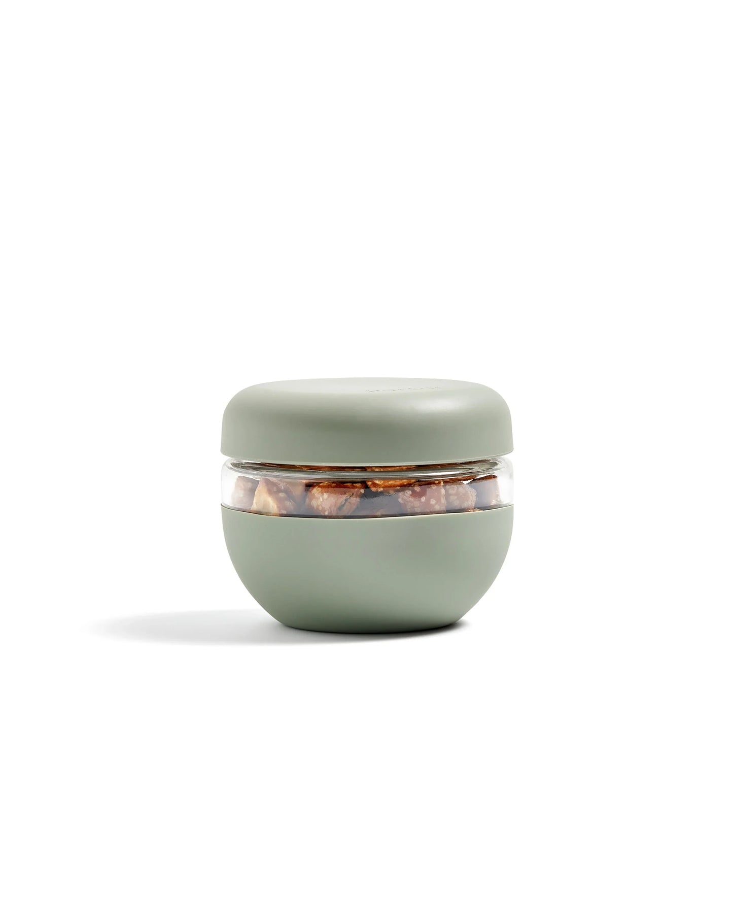 Sage green airtight food storage container with snacks, minimalist design, on white background