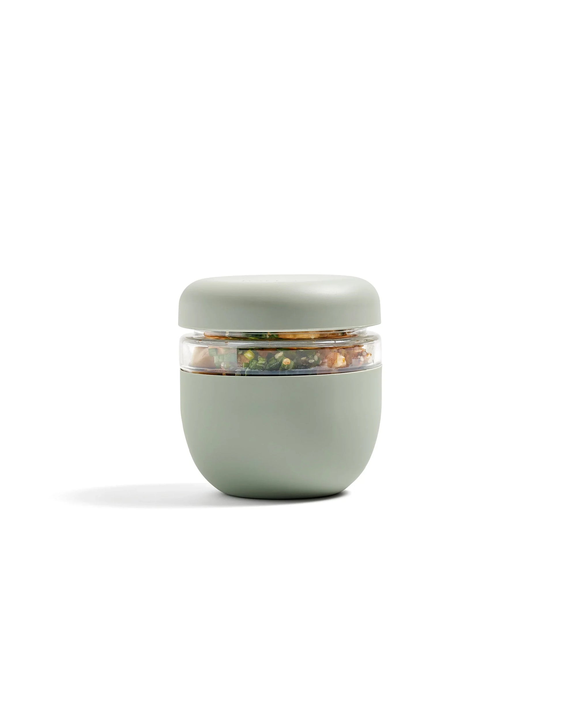 Sage green insulated food container with clear middle, filled with salad, on white background