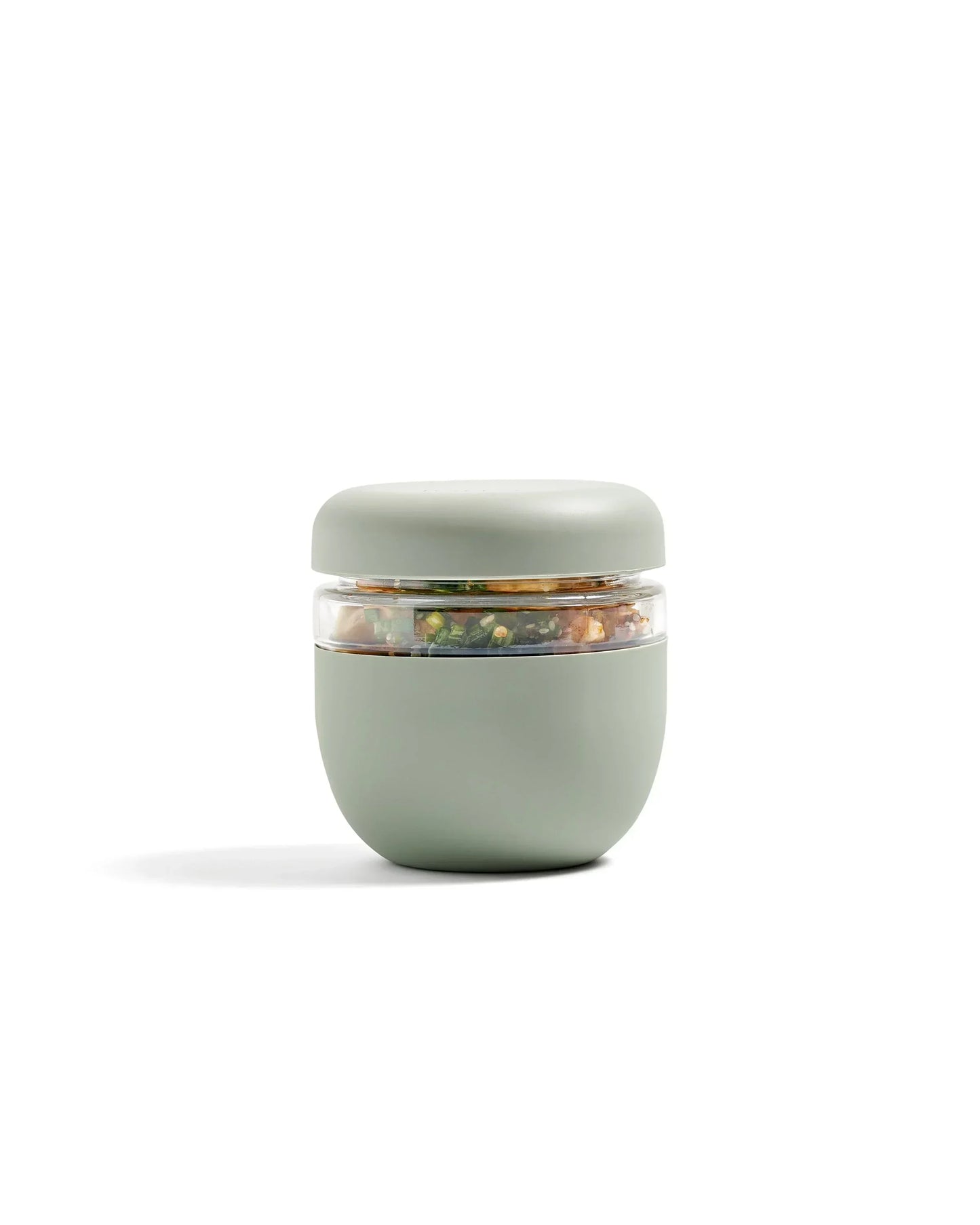 Sage green insulated lunch container with clear seal, filled with salad, modern design