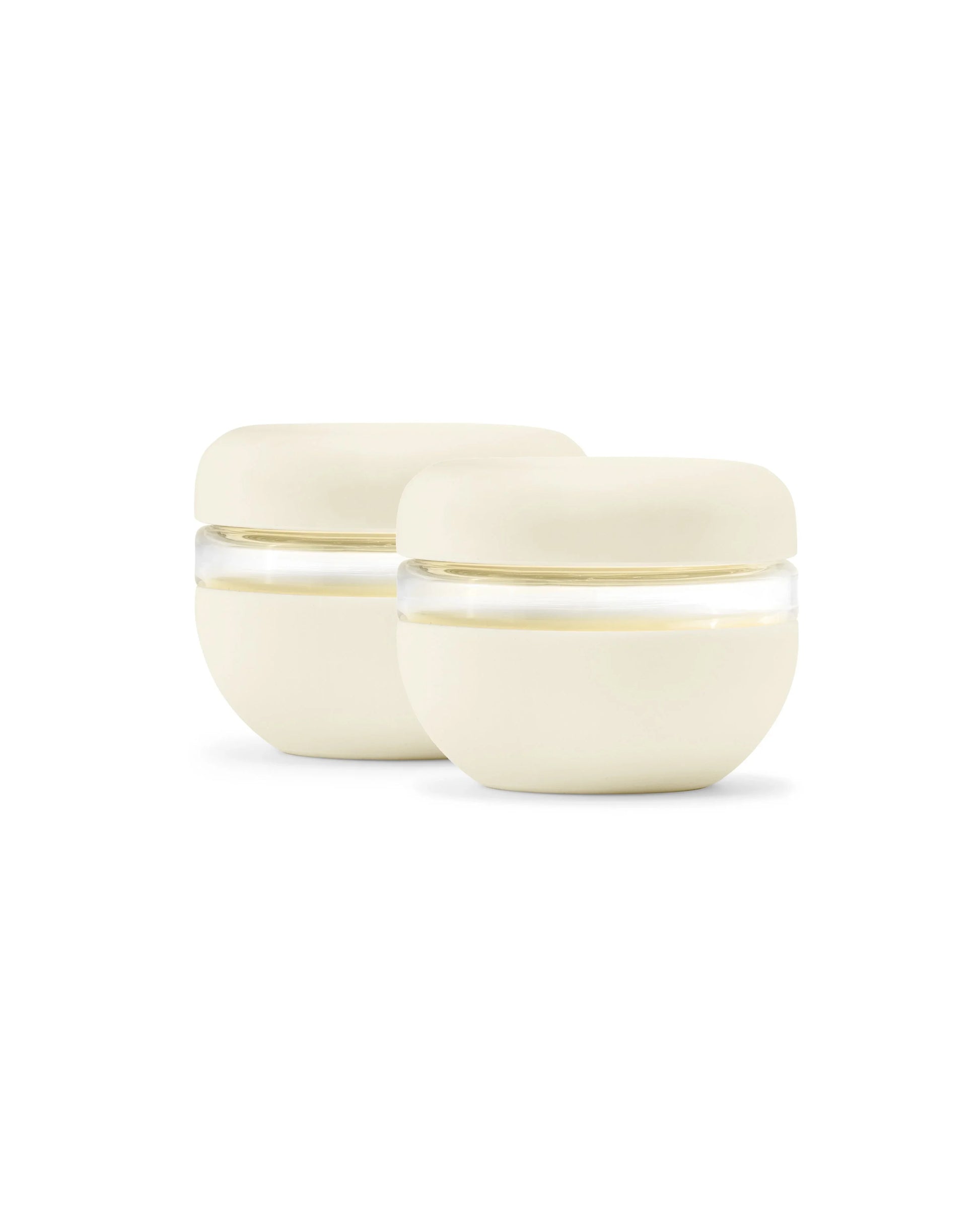 Cream-colored round airtight food storage containers set on white background