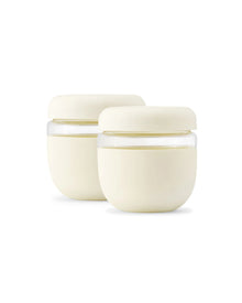 Pair of cream airtight food storage containers with lids, ideal for meal prep or lunch.