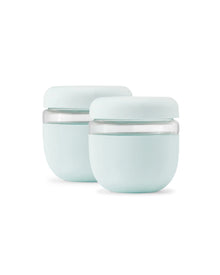 Set of two mint green airtight lunch containers with clear bases and matching lids.