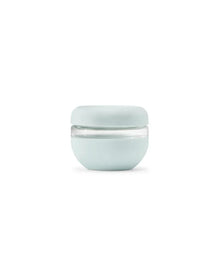 Mint green insulated food storage container with clear middle section on white background