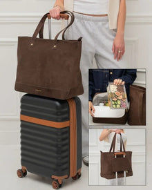 Brown insulated vegan leather tote bag on suitcase, open to show lunch container inside