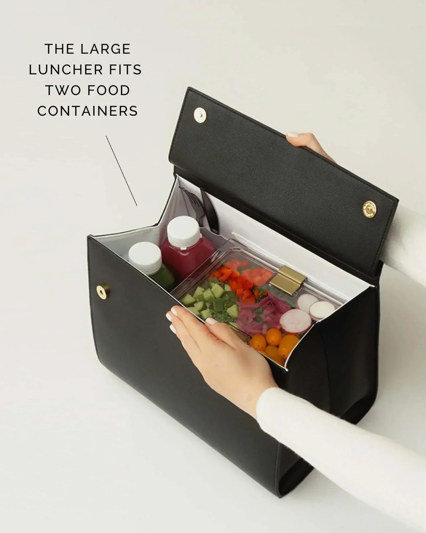 Open view of large black luncher showing space for two food containers
