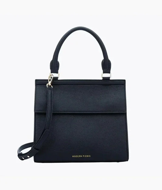Black vegan leather insulated lunch bag with a top handle and shoulder strap.