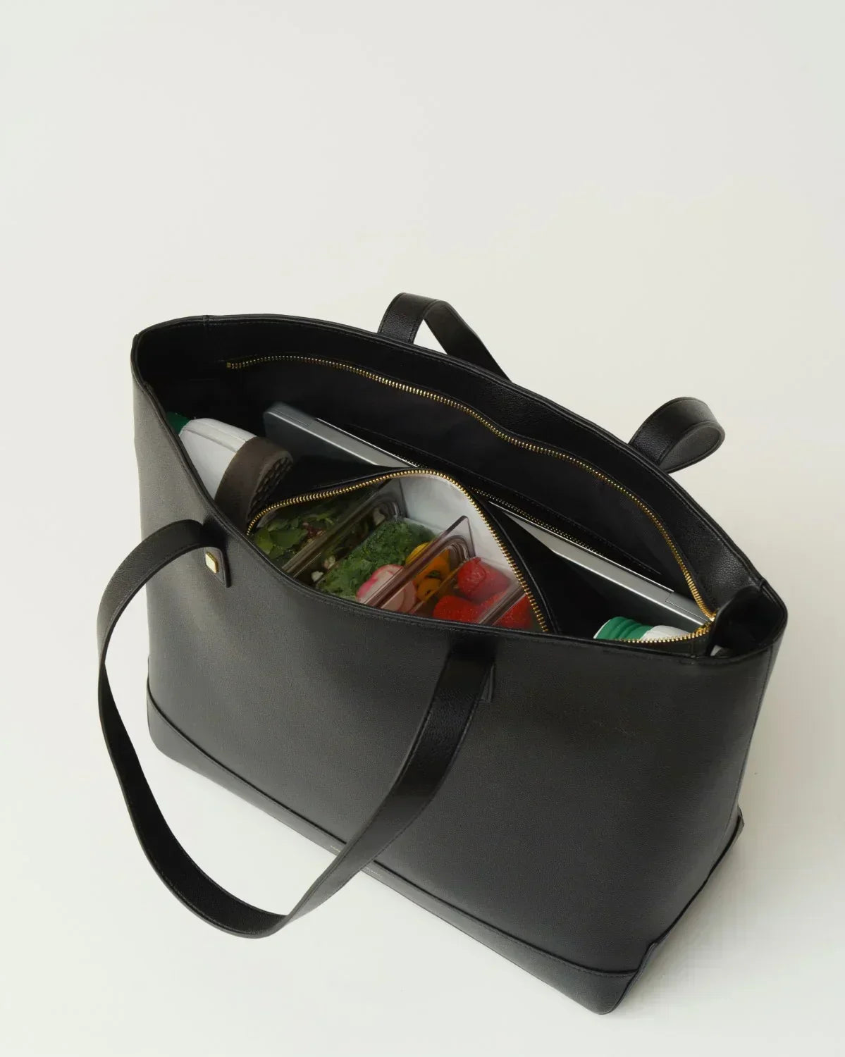 Open Modern Picnic black croc tote bag showing insulated interior filled with lunch containers and snacks