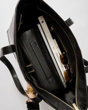 Inside view of Modern Picnic black pebble tote bag showing laptop, sunglasses, and compartments