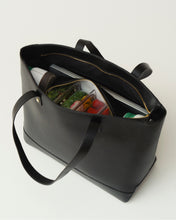 Open Modern Picnic black pebble tote bag showing organized interior with insulated compartment and packed food
