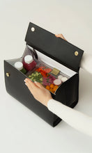 Modern Picnic black croc bag opened to reveal food containers and essentials neatly packed inside.
