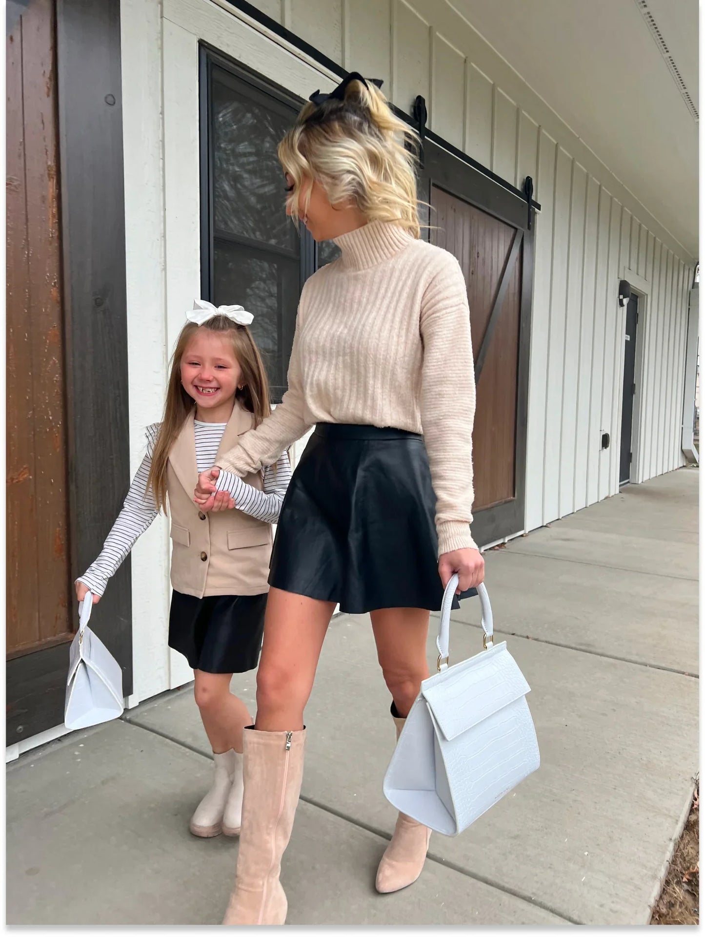 Mother and daughter walking hand in hand outdoors, each carrying a Modern Picnic Mommy and Me Set bag.