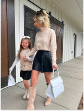 Mother and daughter walking hand in hand outdoors, each carrying a Modern Picnic Mommy and Me Set bag.