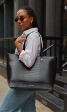 Woman carrying the Modern Picnic black tote from THE ORIGINALS SET over her shoulder, styled for work or travel.