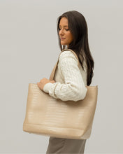 Woman carrying Modern Picnic tote in cream croc vegan leather on her shoulder in a neutral-toned studio setting.