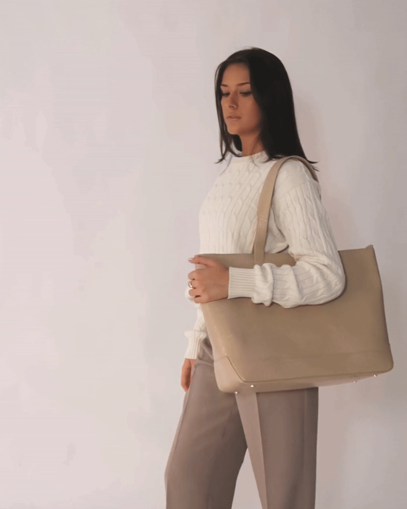 Model posing with Modern Picnic tote in cream croc vegan leather, styled with beige trousers and a white sweater.