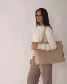 Model posing with Modern Picnic tote in cream croc vegan leather, styled with beige trousers and a white sweater.