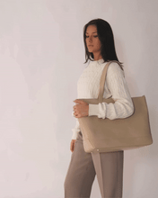 Model posing with Modern Picnic tote in cream croc vegan leather, styled with beige trousers and a white sweater.