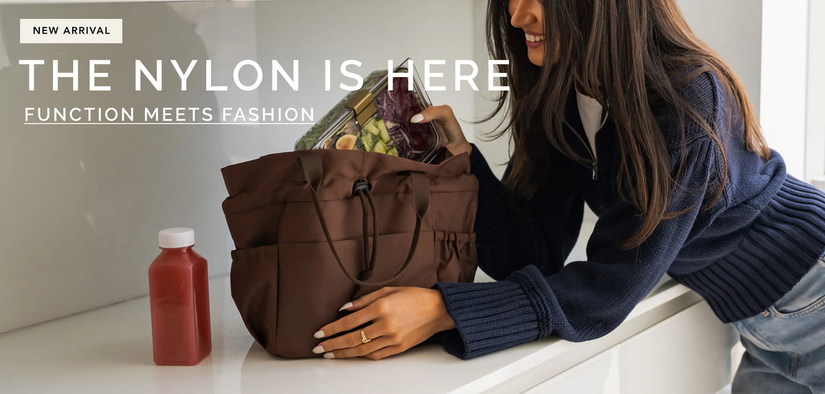 Woman placing a clear glass meal prep container into a brown nylon insulated lunch tote bag.
