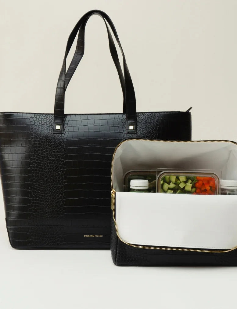 Black croc-embossed vegan leather insulated lunch tote with food containers inside.