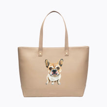 A studio shot of a large cream tote bag featuring a custom hand-painted portrait of a tan and white French Bulldog sitting on the front.