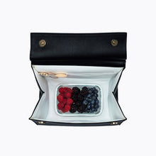 Open Modern Picnic black luncher showing fruit container inside insulated compartment.
